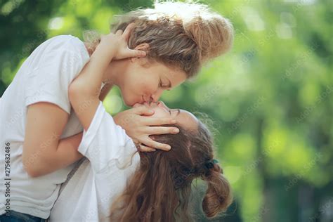 mother and daughter kiss